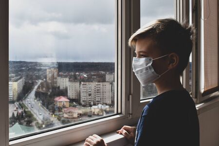 The boy wants to walk on the street. the child looks from the balcony. Home quarantineの写真素材