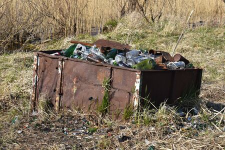 Glass in the grass. Trash in the woods. Protection of nature