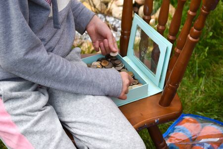 Kids playing with coins. Children's toy store.の写真素材