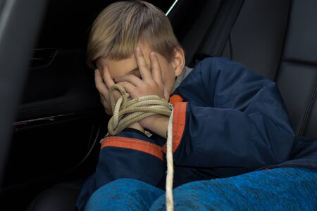 Kidnapped boy in the car. Related children's hands. stealing peopleの写真素材