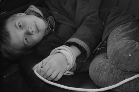 the captive child in the car. Illegal theft and ransom of a childの写真素材