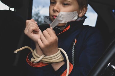 kidnapping and selling children into slavery. rescue of boy from captivityの写真素材