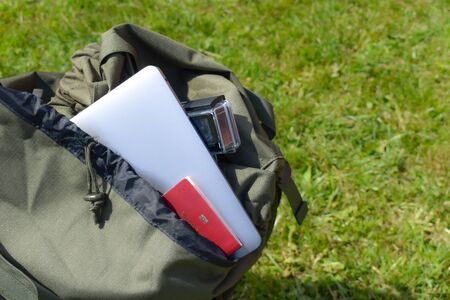 picking up things to travel in a backpack. Passport and laptop in a bag.の写真素材