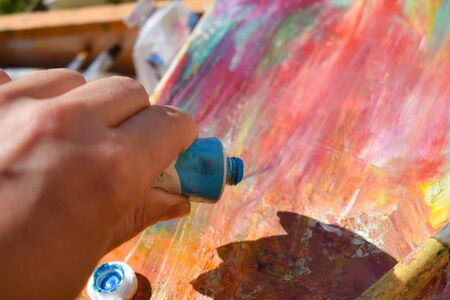 The artist paints a picture in oil. The picture is picturesque. art therapyの写真素材