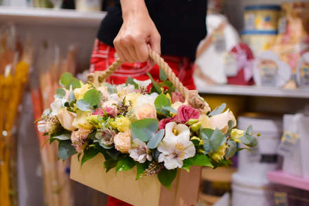 beautiful girl with a bouquet of flowers in hands. fresh flowers delivery. girl sniffing flowersの写真素材