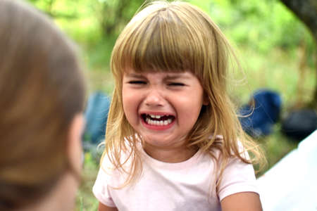 Little girl child of two years crying. Portrait of crying baby caucasian