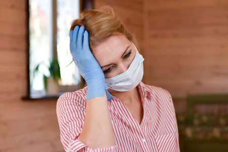 Woman in medical mask at home. Medical person with mask on face. observe virus protection measures....