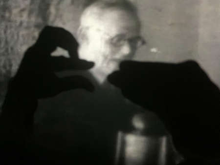 play of shadows on the screen. Finger shadow figures on the wall. People are fooling around in the cinema. Black white cinema.のeditorial素材