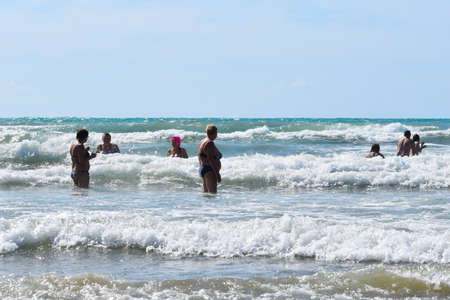 people tourists swim in the sea in summer. happy holidays on the seaside.のeditorial素材