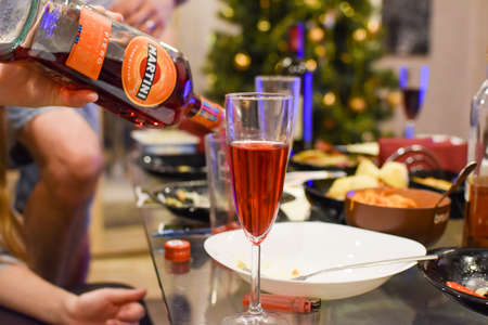 dirty dishes on the festive table after the party. glasses and bottles on the New Year's tableのeditorial素材