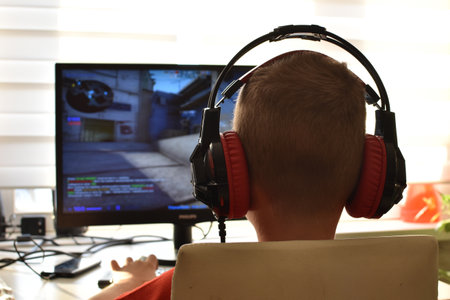 boy is playing an online game on the internet. children's gambling addiction. online learning