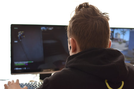 boy is playing an online game on the internet. children's gambling addiction. online learningの写真素材