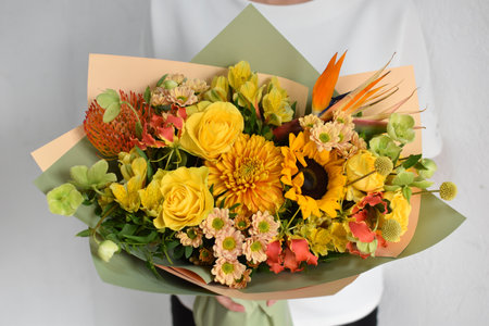 woman with bouquet of flowers. Beautiful flowers for holiday. Woman with beautiful flowers in hands indoors background. bouquet of flowers for flower shop.の写真素材