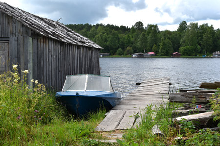 old wooden house in the village in the forest. rural peaceful landscapeの写真素材