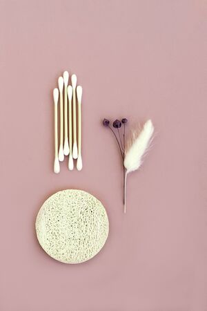 Bamboo cotton buds, sponge cleansing from natural loofah for the face, dried flowers on pinkの写真素材