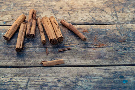 Organic Raw Brown cinnamon sticks on old wooden table wood stump trunk outdoorの写真素材