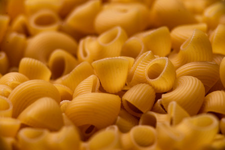 dry raw Italian pasta pipe rigate Diet and food concept Uncooked Macaroni background texture Stack closeup top viewの写真素材