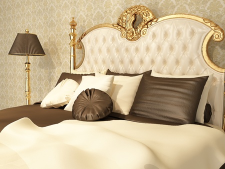 Luxurious bed with pillows and standing lamp in royal interiorの写真素材