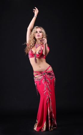 beautiful belly dancer woman on black backgroundの写真素材