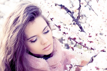 Beautiful Spring Girl with flowers, outdoorsの写真素材