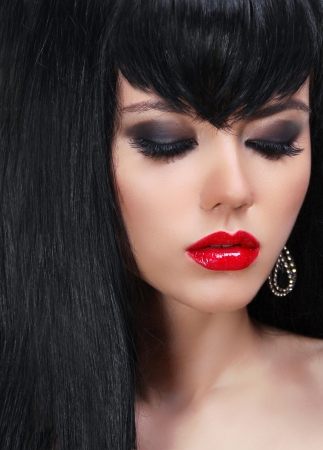 Fashion brunette woman portrait with red lips and Long Hair.  の写真素材