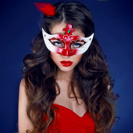 Masquerade. Beautiful Girl in Carnival mask with long curly hairの写真素材