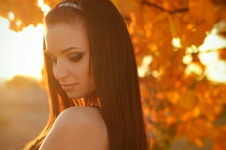 Sunset Autumn young woman portrait. Soft sunny colorsの写真素材