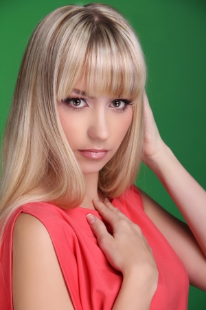 Portrait of beautiful female model on green background. Beautiful girlの写真素材