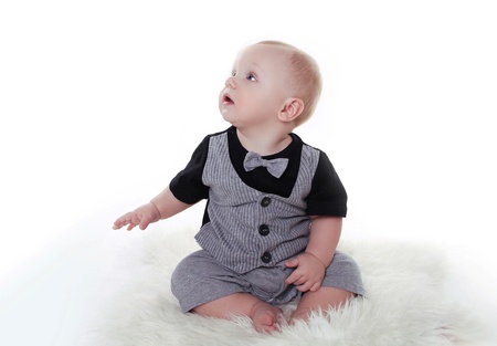 little baby boy wearing in gentleman suit sitting over white backgroundの写真素材