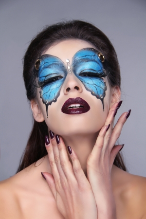 Fashion Make up. Butterfly makeup on face beautiful woman. Art Portrait.の写真素材