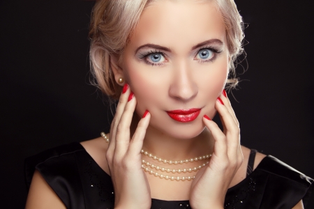 Close up of blue eyes. Retro woman with make up and red nailsの写真素材