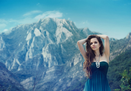 Attractive free girl enjoying life, outdoors in mountains landscape.の写真素材