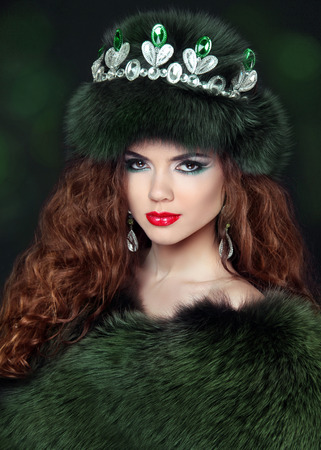 Beautiful brunette woman in mink fur coat. Jewelry. Fashion Beauty girl model with long healthy wavy hair styling.の写真素材