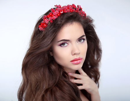 Beauty Woman with chaplet, face Portrait. Beautiful girl model with makeup. Brunette female looking at camera. Youth and Skin Care Concept. Over studio backgroundの写真素材