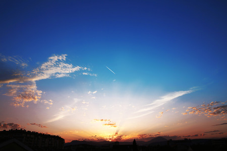 Sunset with clouds, light rays, blue sky, natural background. atmospheric effectの写真素材