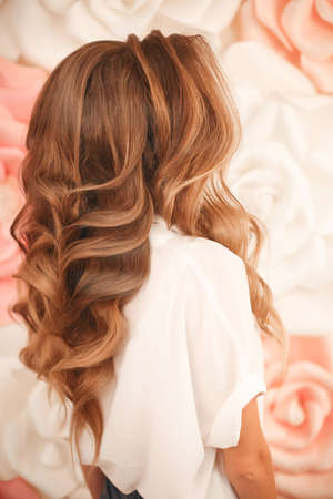 Healthy hair. Wavy long hairstyle. Back view of Blond hair styling. Wedding day. Bride High Fashion...