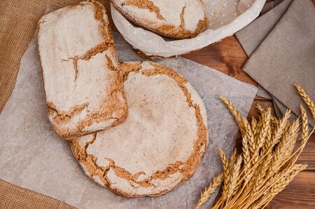 Delicious homemade bread on the table with ears of corn. Quarantined homemade cakes. Sourdough rye...