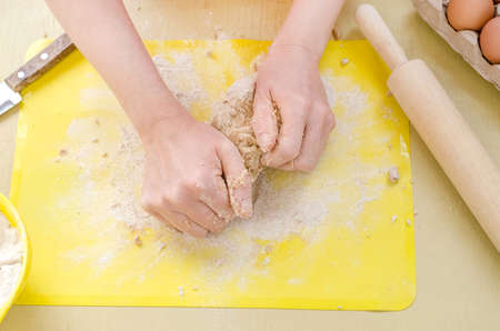 Step by step preparation of fresh hand-made pasta from whole grain flour . Step 4 - kneading the...