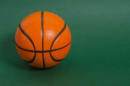 Basketball ball on a green background with copy space. Announcement of basketball matches.の写真素材