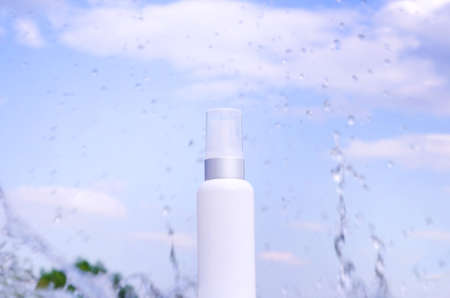 Moisturizing cream. Tube against the background of a splash of water against the blue sky.の写真素材