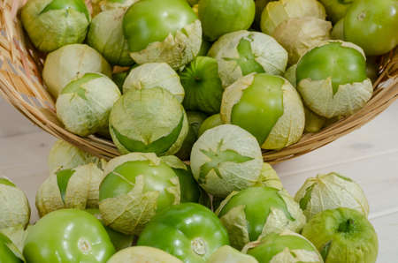 Fresh ripe fruits of vegetable physalis with husk close up on white background