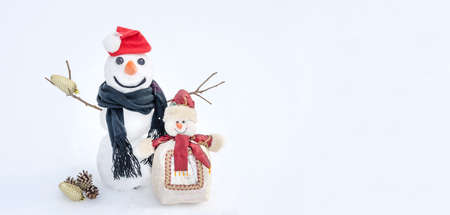 Christmas and New Years background card with copy space, snowmen on a snow background with Christmas balls.の写真素材