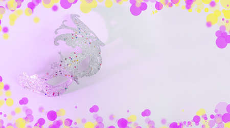 Carnival mask on white background with colored light with copy space for Mardi Gras, Brazilian, Venetian carnivalsの写真素材