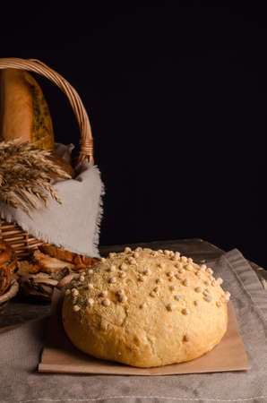 Beautiful loaf of white bread with a curly top with copy space on a wooden backgroundの写真素材