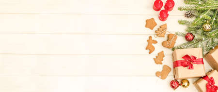 Christmas and New Year card with a composition of gifts, Christmas tree decorations and gingerbread...