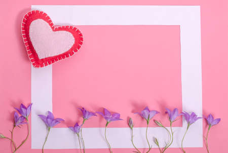 Valentine's day pink background with heart and lilac flowers with copy space.の写真素材