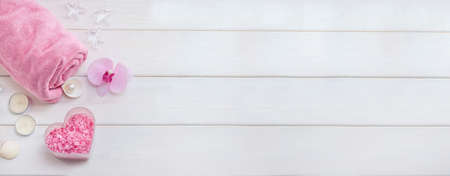 Background baner with pink spa accessories as a gift for Valentines Day on white wooden boards with copy spaceの写真素材
