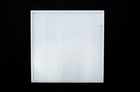 Large square modern LED lamp with plastic body isolated on black background with copy space
