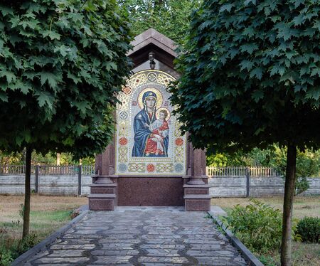 large icon of the Mother of God, among the trees, on a warm day, close-upの写真素材
