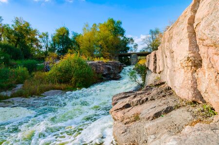 the river Gorny Tikic flows among the rocks and canyon, in a warm sunny autumn afternoon, in the village of Buki, Ukraineの写真素材